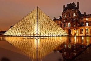 One of Frances most famous museum the Louvre lit up at night.